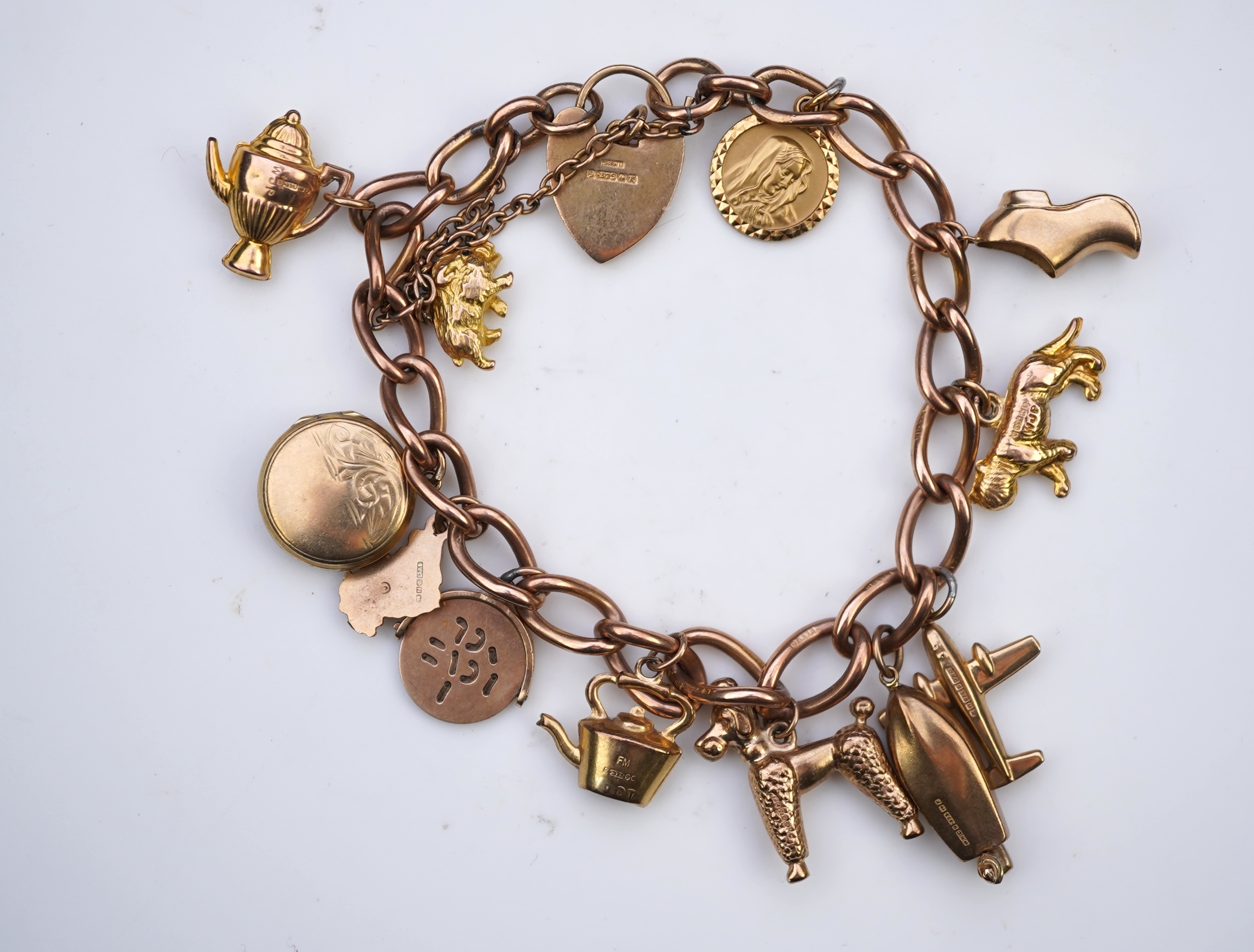 A gold charm bracelet, mid 20th century